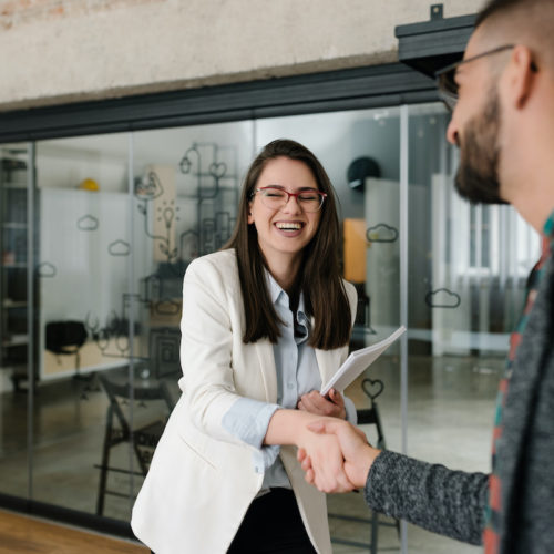 Handshaking and smiling candidly at a job interview