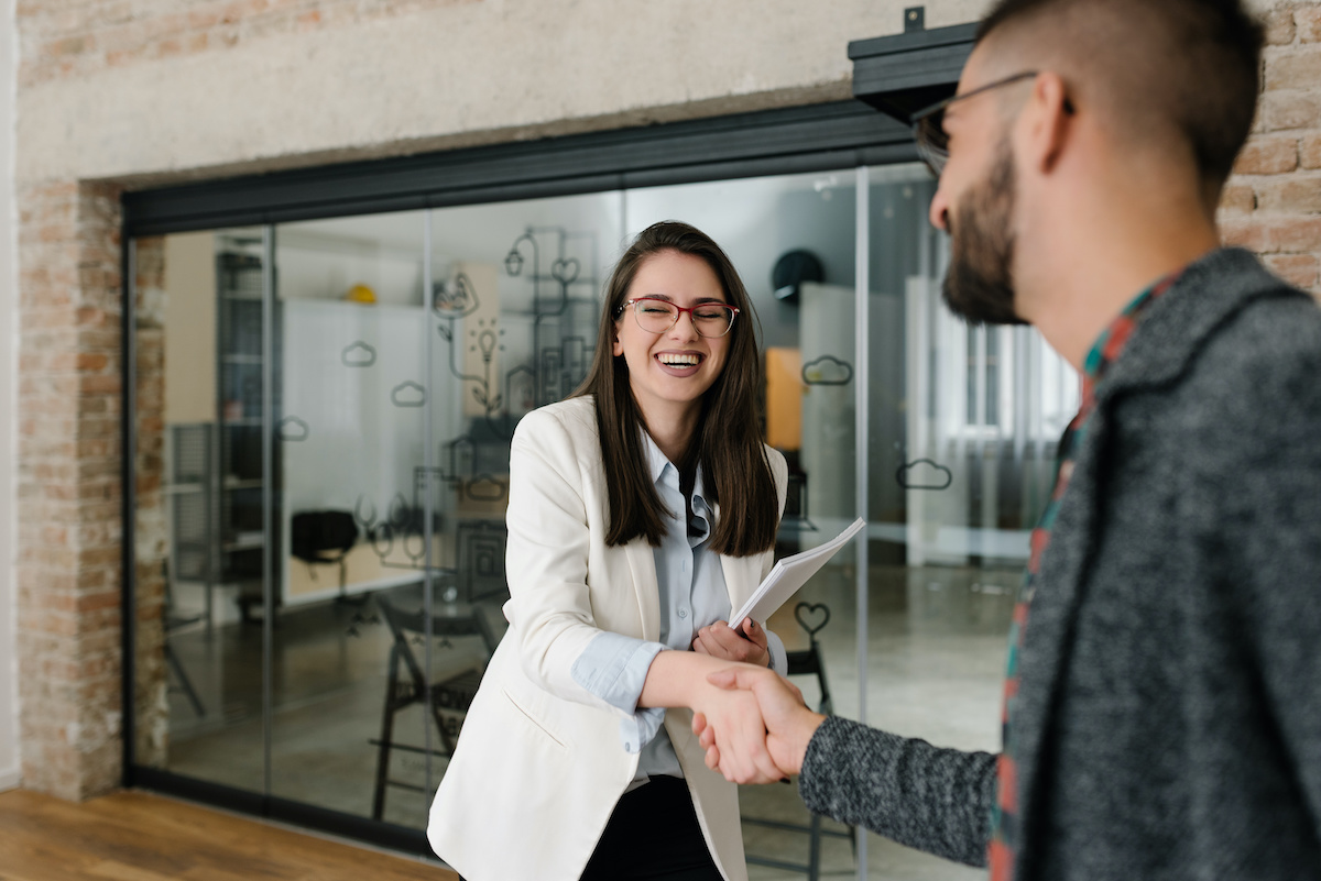 Handshaking and smiling candidly at a job interview