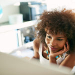 Happy employee working on computer