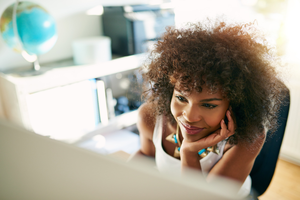 Happy employee working on computer